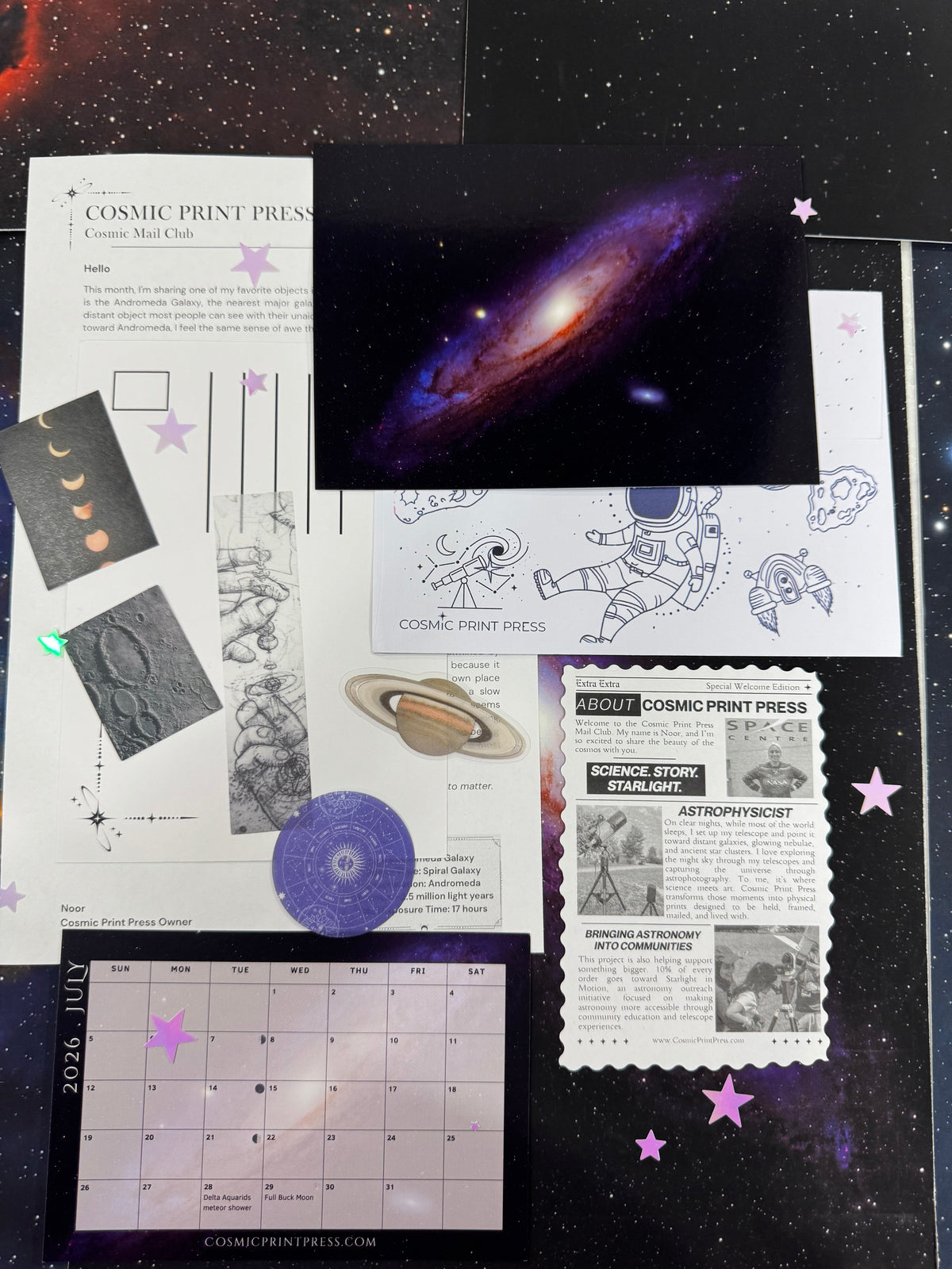 A flat lay of a space-themed educational or craft kit from Cosmic Print Press, featuring a galaxy print, astronaut sketches, a moon phase chart, a space calendar, and a science story card on a dark starry background. Photos are taken by Noor and Astrophysicist who uses her telescope to capture the images featured in her astronomy space themed mail club